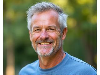 Happy man in his 50s, outdoors, looking healthy and active.